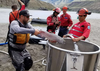 Crews move salmon to a bucket for hoisting by helicopter over the five-metre waterfall in the Fraser River created by the Big Bar slide.