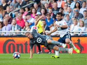 Vancouver Whitecaps midfielder Felipe Martins, right, defends against Minnesota United Osvaldo Alonso during Saturday's Major League Soccer match at Allianz Field in Saint Paul, Minn.