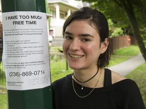 Julia De La Puente puts up one of her " Too Much Time "posters Vancouver, July 11 2019. The 19 year old Emily Carr student is looking to find summer work.