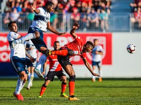 Cavalry FC attacker Dominique Sossorobla Malonga (23) pursues the ball against Vancouver Whitecaps during the first half during a Canadian Championship soccer match at Spruce Meadows.