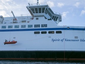 A zodiac lowered during a rescue drill is dwarfed by the Spirit of Vancouver Island during recent exercises.