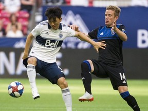 VANCOUVER July 20 2019. Vancouver Whitecaps #4 Hwang In-Beom keeps the ball from San Jose Earthquakes #14 Jackson Yueilli in a regular season MLS soccer game at BC Place, Vancouver, July 20 2019. Gerry Kahrmann / PNG staff photo) 00058157A Story by JJ Adams [PNG Merlin Archive]