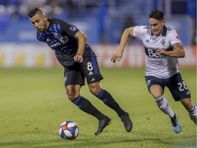 Montreal Impact's Saphir Taider, left, takes the ball away from Vancouver Whitecaps Jakob Nerwinski during MLS action in Montreal on Aug. 28, 2019.