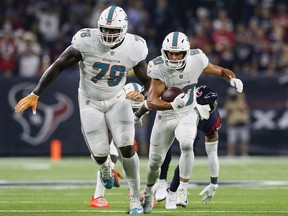 Miami Dolphins offensive lineman Laremy Tunsil (left) runs interference for receiver Danny Amendola during an Oct. 25, 2018 NFL game against the Houston Texans at NRG Stadium in Houston, Texas.