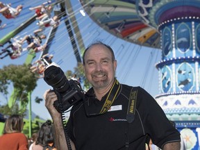 PNE photographer Craig Hodge by the Wave Swinger ride on Aug. 27.
