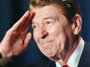 In this file photo taken on January 27, 1988 former US President Ronald Reagan is shown in Washington, DC saluting to members of the Reserve Officers Association. In October 1971, the then-California governor made racist remarks about Africans in a newly-discovered taped conversation with US president Richard Nixon.