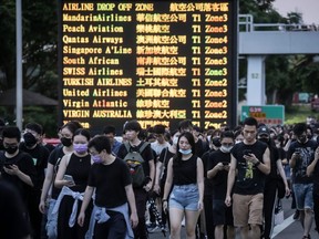 Protesters walk on a highway near Hong Kong's international airport following a protest against the police brutality and the controversial extradition bill on Aug. 12, 2019.