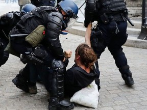 French police detain a man during an anti-G7 Summit demonstration in the city of Bayonne, France, on Aug. 24, 2019, on the sidelines of the annual summit attended by the leaders of the world's seven richest democracies taking place in the seaside resort of Biarritz.