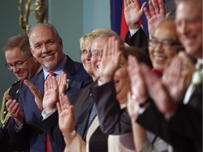 Premier John Horgan smiles at cabinet members after being sworn-in as Premier during a ceremony with his provincial cabinet at Government House in Victoria, B.C., on Tuesday, July 18, 2017. Photo: Chad Hipolito/CP