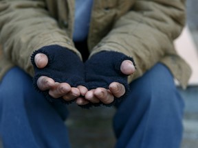 Homeless man is holding hands to get help.