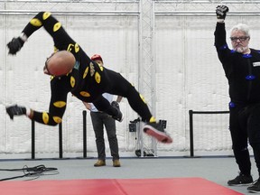 Stuart Derdeyn, right, sends Max Harvey flying as they act out their characters in a video game at Beyond Capture motion-capture studio in Vancouver on Aug. 17.