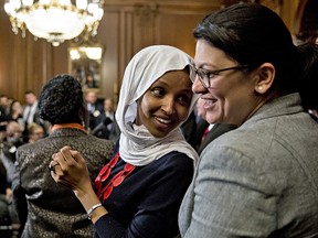 Representative Ilhan Omar, a Democrat from Minnesota, left, speaks with Representative Rashida Tlaib, a Democrat from Michigan, during a news conference in Washington, D.C., U.S., on Wednesday, March 13, 2019.