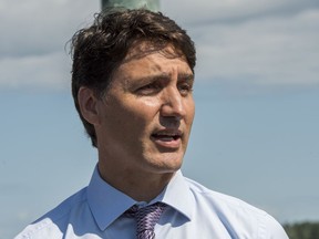 Prime Minister Justin Trudeau speaks next to the Watermark sculpture along the St. John River in Fredericton, N.B. on Thursday August 15, 2019.