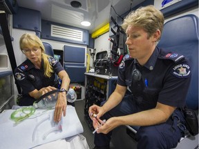 In this file photo, paramedics Jill (left) and Stefan display the ventilation bag with airways and the Naloxone and needle that are used to reverse the effects of a fentanyl overdose.
