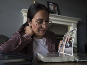 Jessica Sherman looks through pictures of her cousin at her home in Abbotsford, B.C., Wednesday, June 19, 2019.