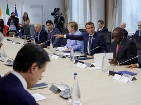 French President Emmanuel Macron, Britain's Prime Minister Boris Johnson, German Chancellor Angela Merkel, Canada's Prime Minister Justin Trudeau attend a working lunch with invited guests to discuss the digital transformation during the G7 summit in Biarritz, France, August 26, 2019.