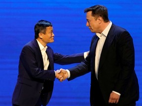Tesla Inc CEO Elon Musk and Alibaba Group Holding Ltd Executive Chairman Jack Ma shake hands at the World Artificial Intelligence Conference (WAIC) in Shanghai, China, August 29, 2019.