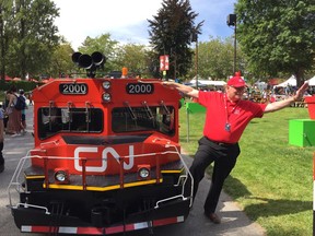 Retired CN employee and spokesman of the interactive display at the PNE Fair in Vancouver shows off the mini train that fairgoers can ride as part of the railway's display at the annual summer attraction.