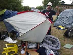 Gary tosses his old tent onto a pile of rubbish at Oppenheimer Park.