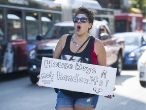 Amanda Jabbour leads a chant as protesters concerned with the possible eviction of a Oppenheimer Park homeless camp take over the intersection at East Hastings and Gore outside the B.C. Housing Office on Thursday.