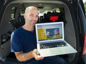 John Perlinger shows off the Charitables.com website. Perlinger, who grew up in poverty, and his wife, a Romanian refugee have started the website which allows people to sell your unwanted stuff with the proceeds going to charity. Photo: Arlen Redekop/Postmedia