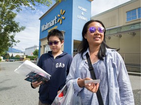 Thy Huynh and son Peter, 13, outside Walmart in Vancouver.