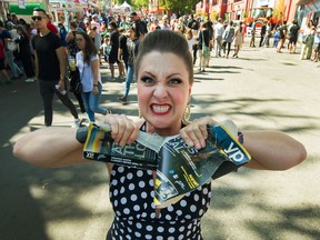 Strong Woman Mama Lou rips an Austin telephone book in half with her hands. Mama Lou will be putting on three shows a day at the PNE this week. Photo: Arlen Redekop/Postmedia