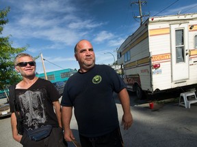 J.P. Lorence (left), who is homeless, and Peter Vinccelli, who rents out the camper (at right) to homeless people in Vancouver.