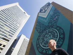 Artist Shepard Fairey with his mural Earth Justice on the side of 1030 W Georgia in Vancouver.