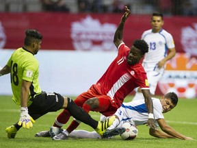 Tosaint Ricketts, in red, collides with El Salvador goalkeeperOscar Arroyo during 2018 FIFA World Cup qualifier action at B.C. Place Stadium on Sept. 6, 2016.