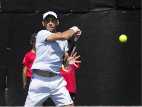 Benjamin Sigouin of Vancouver returns a shot against Australian Marc Polmans during Wednesday's action in the Odlum Brown VanOpen tennis tournament at the Hollyburn Country Club. Sigouin lost his singles match, but remains alive in the doubles competition.