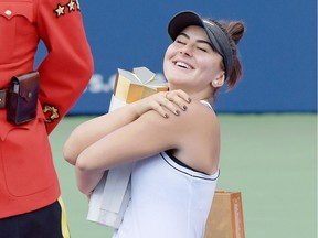 Canadian tennis star Bianca Andreescu hugs the winner's trophy after defeating Serena Williams of the United States in the women's singles final at the Rogers Cup tennis tournament in Toronto earlier this month.