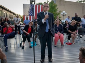 Ohio Governor Mike DeWine reacts as vigil attendees shout "Do Something" while he was speaking at a vigil at the scene after a mass shooting in Dayton, Ohio, Aug. 4.