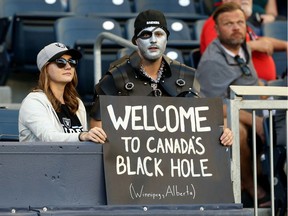 Oakland Raiders fans have fun with their sign during Thursday's NFL pre-season game between the Raiders and Green Bay Packers at IG Field in Winnipeg. Players on the Raiders, trying to promote the Canadian game, wore T-shirts saying Winnipeg, Alberta.