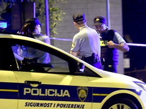 Police officers stand guard at a checkpoint near the place where six people were shot dead in Zagreb on Aug. 1, 2019.