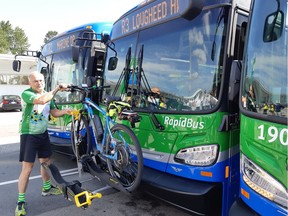 Coquitlam Mayor Richard Stewart loads his bicycle on a new RapidBus.