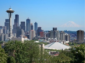 The Seattle skyline with the Space Needle and Mount Rainier floating in the background. Political and business leaders from B.C., Washington state and Oregon gather this week in Seattle for the Cascadia Innovation Corridor Conference.