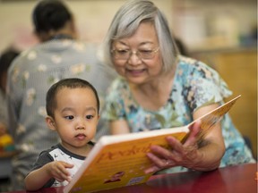 Marjorie Lam reads to her grandson Markus Toye.