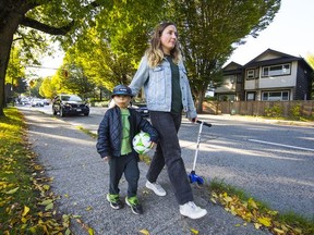 Kate Walker and her son Jules walk near Strathcona Park, where the high volume of vehicle traffic makes just walking on the sidewalk a dangerous proposition. Vancouver council is expected to consider the route for a new east-west arterial through the area.
