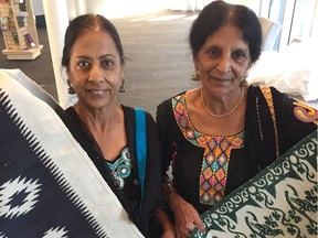 Amarjeet Boparai (left) and Gurmeet Khosa each are holding their own durrie which they made by hand. In Punjab, a durrie is traditionally used to cover a bed. Both durries along with the stories of the two women are in the exhibition Being Punjabi: Unfolding the Surrey Story which opens Wednesday and continues to Sunday, Feb. 23, 2020 at the Museum of Surrey. Photo: Kevin Griffin