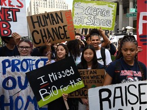 People gather during the Global Climate Strike march at Foley Square in New York September 20, 2019. Crowds of children skipped school to join a global strike against climate change, heeding the rallying cry of teen activist Greta Thunberg and demanding adults act to stop environmental disaster. It was expected to be the biggest protest ever against the threat posed to the planet by climate change.