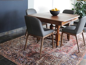 The area rug defines the dining space in this open concept layout by Lori Steeves of Simply Home Decorating.