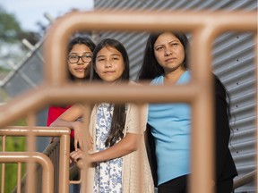 Rina Diaz and her daughters Alexia Sandoval (middle) and Yesenia Sandoval walk in front of Frank Hurt Secondary in Surrey. Photo: Gerry Kahrmann/Postmedia