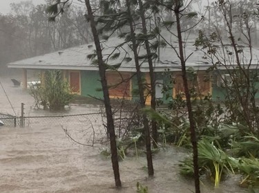 Rain brought on by Hurricane Dorian continues to pour in Freeport, Bahamas, Tuesday, Sept. 3, 2019. Practically parking over the Bahamas for a day and a half, Dorian pounded away at the islands Tuesday in a watery onslaught that devastated thousands of homes, trapped people in attics and crippled hospitals.