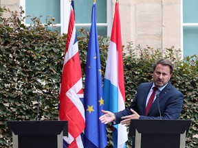 Luxembourg's Prime Minister Xavier Bettel gestures at the podium left vacant by British Prime Minister Boris Johnson in Luxembourg, September 16, 2019.