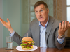 This is an edited photo illustration of Maxime Bernier with a burger platter.