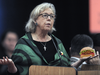 This is an edited photo illustration of Elizabeth May holding a burger.