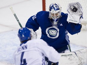 Veteran netminder Richard Bachman makes a slick save on a shot from Jordie Benn during Saturday's session of the Vancouver Canucks' training camp at Save-On-Foods Arena in Victoria.