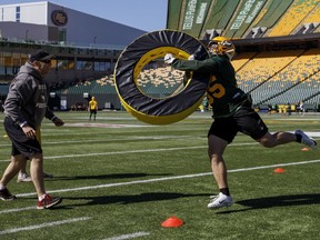 Linebacker Maxime Rouyer of the Edmonton Eskimos runs a tackling drill during the CFL team's training camp in Edmonton on May 19, 2019. Rouyer is from France and has seen special teams duty this season.
