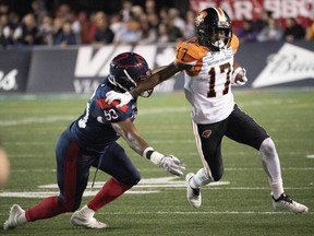 Wide receiver Ryan Lankford of the B.C. Lions fends off Montreal Alouettes' linebacker Frederic Plesius during Friday's CFL action at Percival Molson Memorial Stadium in Montreal. The Alouettes won the game 21-16.